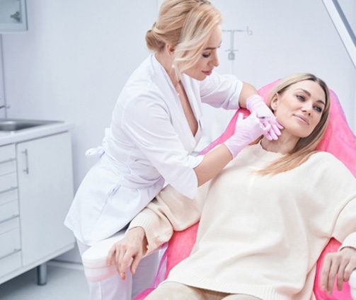 Woman having dermal filler injected