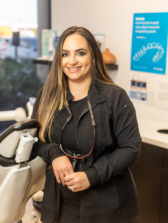 Doctor Sara smiling in the dental treatment room