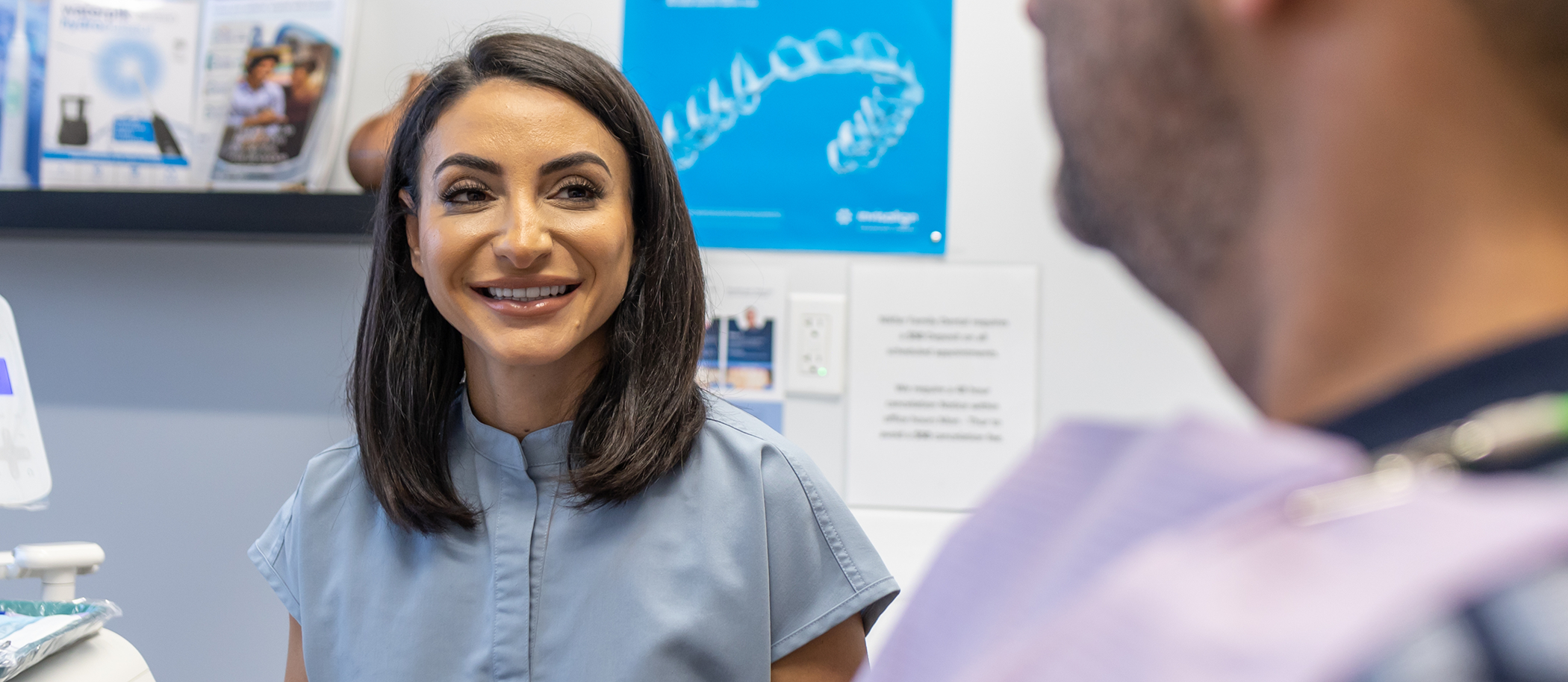 Doctor Roxana smiling at a dental patient