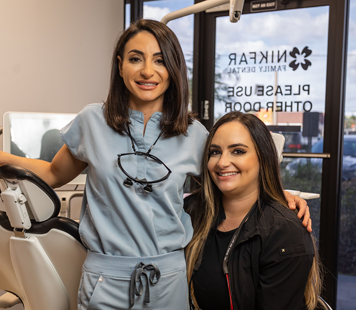 Doctor Sara and Doctor Roxana smiling in a dental treatment room