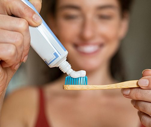 Woman preparing to brush her teeth